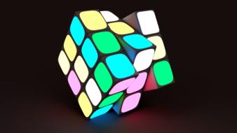 Colorful and beautiful, bright, neon Rubiks cube with lights, among the darkness, on clipart