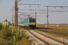 Train on the beautiful railway, among the colorful fields with hay in Gramatneusiedl, Lower Austria