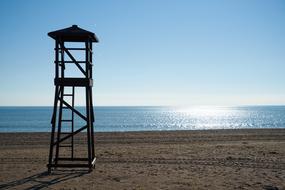 black tower on empty Beach at glossy sea, turkey, antalya