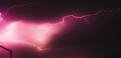 lightning in the pink night sky