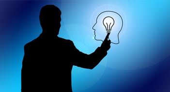 male silhouette pointing at human head outline with lamp inside, drawing