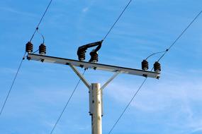 stationary power lines against a blue sky