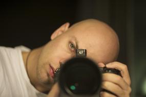 bald man with a professional camera