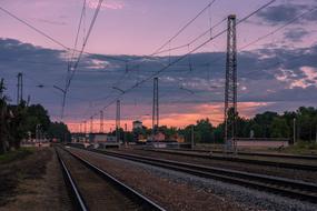 railway tracks on a background of pink-purple sunset in Russia