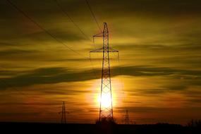 Sun setting behind electric mast