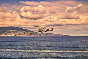 Helicopter flying above the water