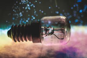 Light bulb on colorful background