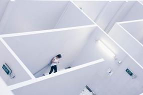 photo of a lonely girl in a white maze