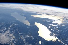 Space view of the colorful Earth with white clouds