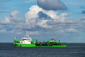 green cargo ship on the north sea