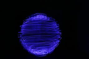 painted blue sphere on a black background
