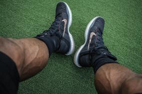 Muscular male legs with sports shoes
