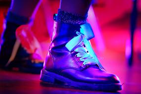 Dark boots among the colorful lights