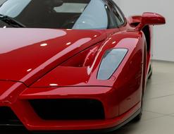 Beautiful, shiny red Ferrari Enzo car with the headlight