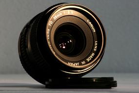 Close-up of the shiny, black lens of the camera with cover