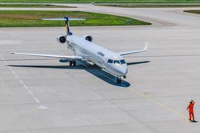 Shiny "Lufthansa" plane in the airport of Germany, near the person