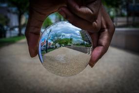 reflection in a glass ball in hand