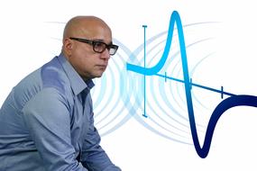 bald man in glasses at abstract Mathematics Curve