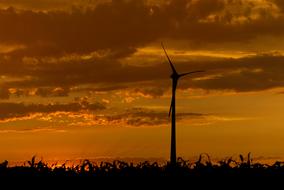 wind turbine against the yellow evening sky