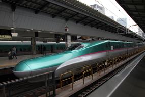 Colorful, shiny train in motion, on the railway, on the station