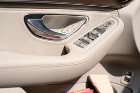 buttons near door in white luxury Car