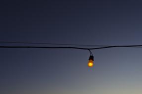 Bulb on Wire at grey sky
