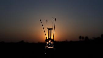 broken lamp on sunset background