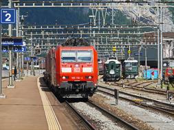 red train at train station in switzerland