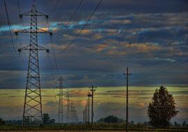 electric towers and poles against the backdrop of a romantic evening sky