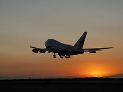 photo of a boeing 747sp taking off at dawn