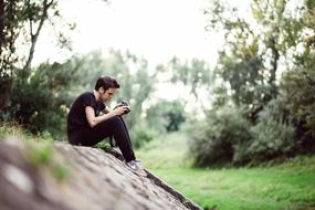 Photographer Sitting on stone