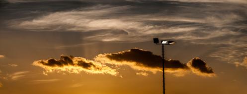 spotlight on the mast against the background of dawn