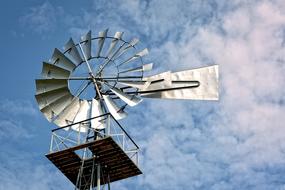 Metal Pinwheel at cloudy sky