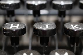 Close-up of the old, black and white keys of the typewriter