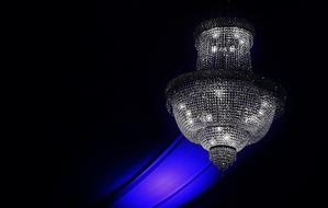 Shiny electric lamp with blue and violet lamp, at black background