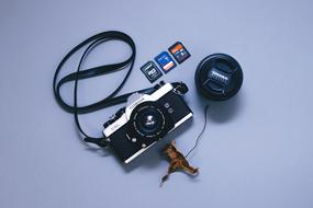 Old camera with lens and colorful memory cards