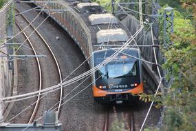 Orange and black train among the plants of the subway of South Korea