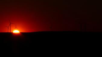 wind turbines on the background of the red night sky
