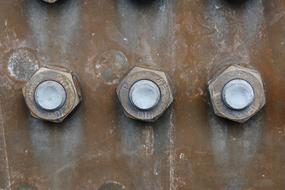 Close-up of the metal screws, on the rusty construction