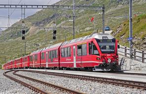 red train on the railway at the Bernina pass