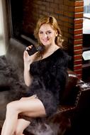 photo of a girl in a black dress with an electronic cigarette