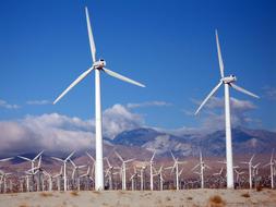 blue sky with white clouds above Wind Farm Turbines