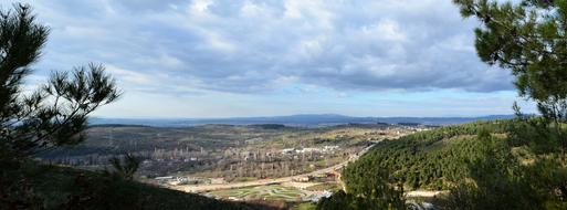 Beautiful and colorful landscape of Doburca, among the green trees under the cloudy sky, on the mountains