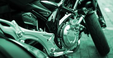 Silver Suzuki motorcycle on the photo in green effect