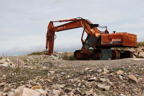 Rusty Old Metal truck Among the rocks at cloudy sky background