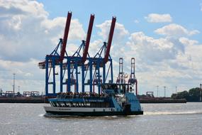 water bus against the background of harbor cranes in Hamburg