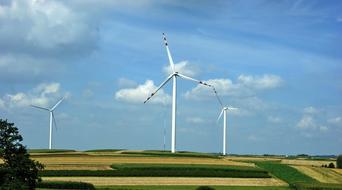 windmill farm in countryside at summer