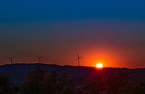 photo of wind turbines against the background of a bright sunset