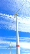 photo of white wind generators against the background of the summer blue sky