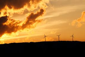 wind turbines against a clear evening sky